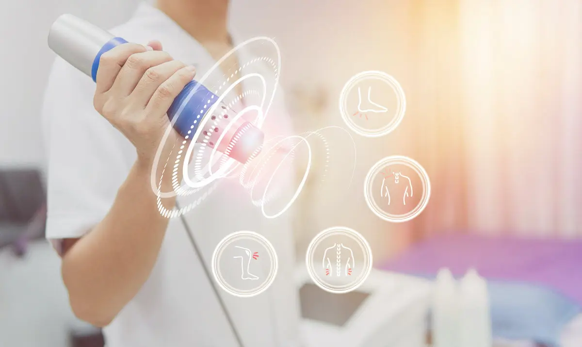 Abstract image of medical staff holding tool to perform shockwave therapy with several icons illustrating various areas it can be applied to: heel, shoulder, back, and knee