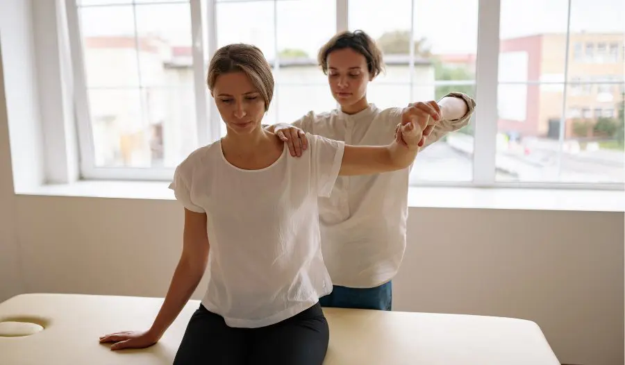 occupational-therapy Chiropractor in Wayne NJ performing a posture assessment with a patient in a bright, modern clinic